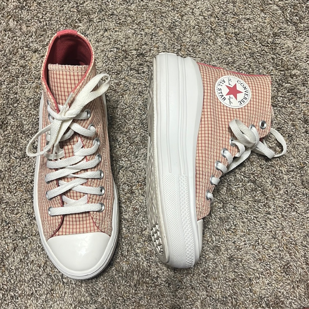 Pink and tan Chuck Taylor converse